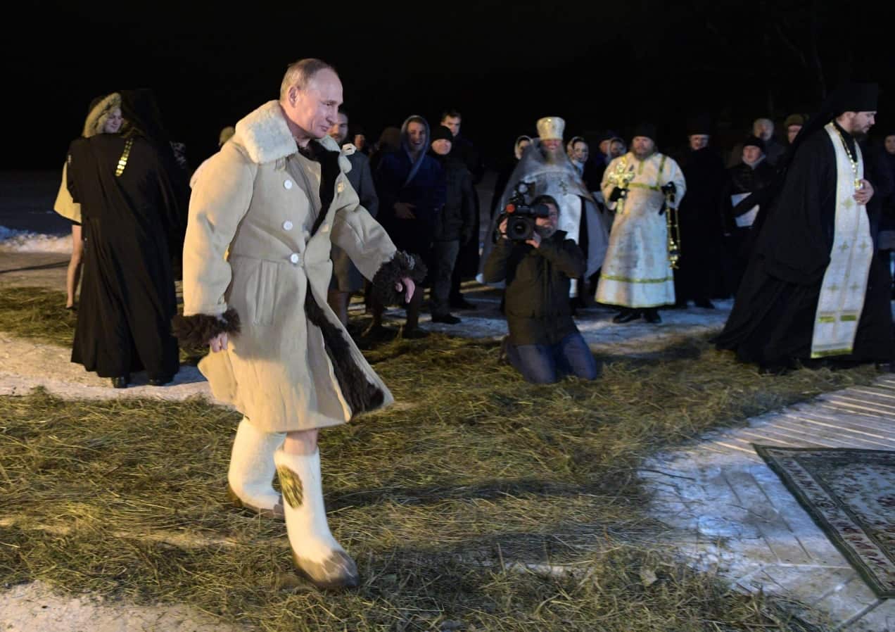 Russian President Vladimir Putin dressed in sheepskin coats walks to bath in an ice-cold water on Epiphany neat St. Nilus Stolobensky Monastery