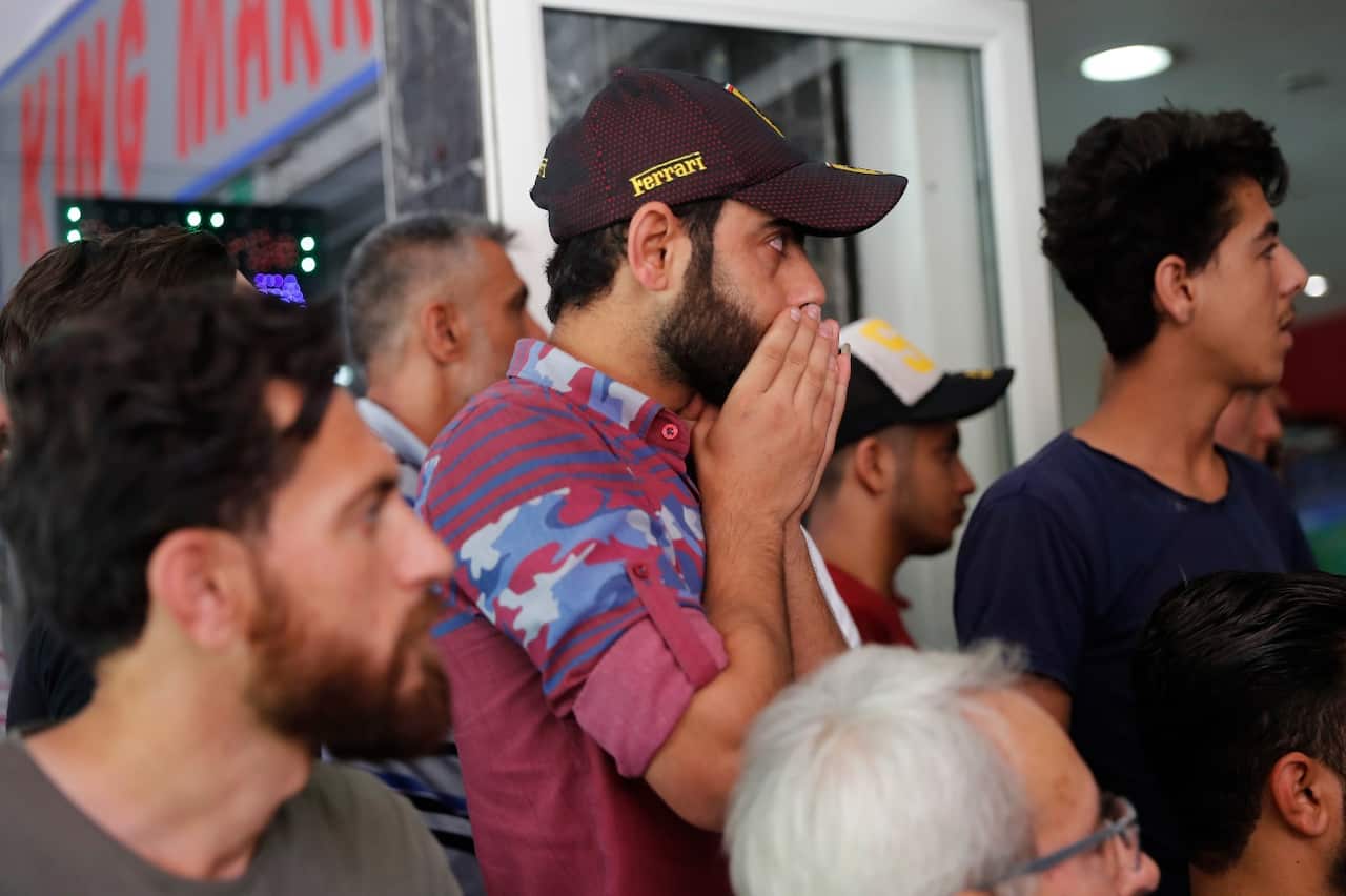 Syrian soccer fans who live in Lebanon, watch the Soccer World Cup qualifying match between Syria and Australia (AAP)