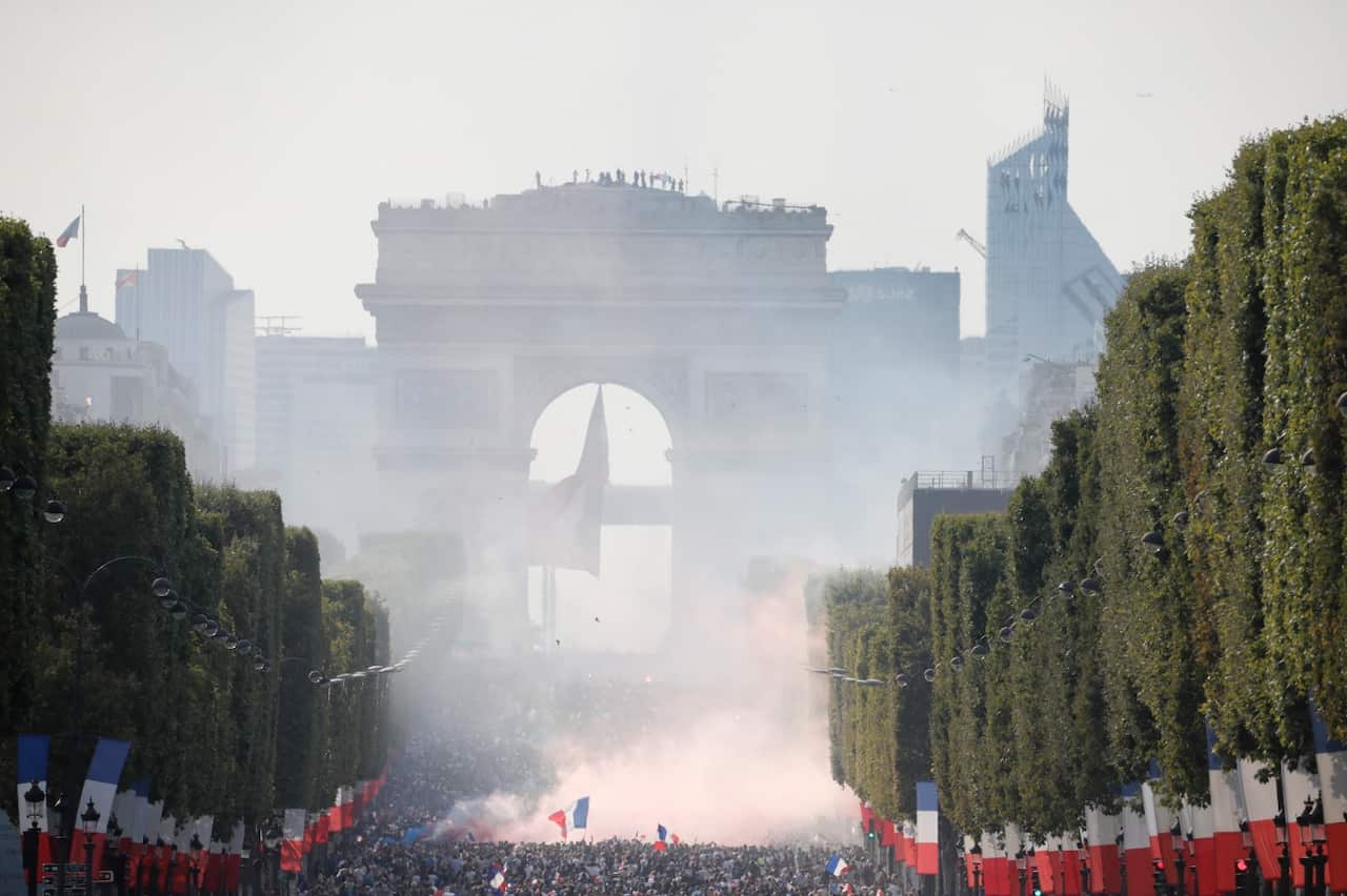 French supporters celebrate after France won the 2018 World Cup at the Champs-Elysees venue
