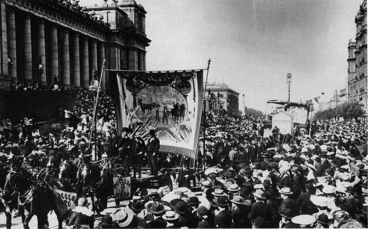 Workers marching for an eight-hour day outside Parliament House in Spring Street, Melbourne, circa 1900.