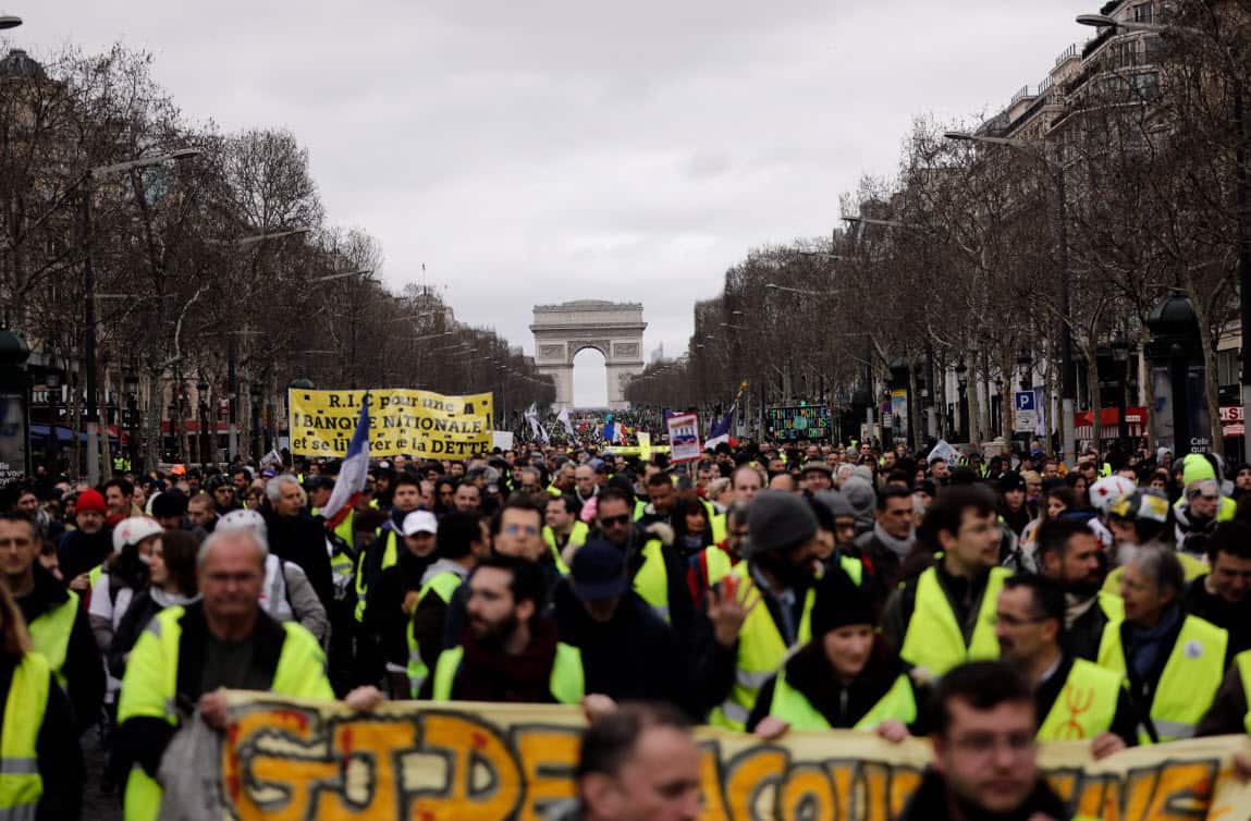 FILE - In this March 2, 2019 file photo, Yellow Vests protesters march on the Champs Elysees avenue in Paris (AAP)