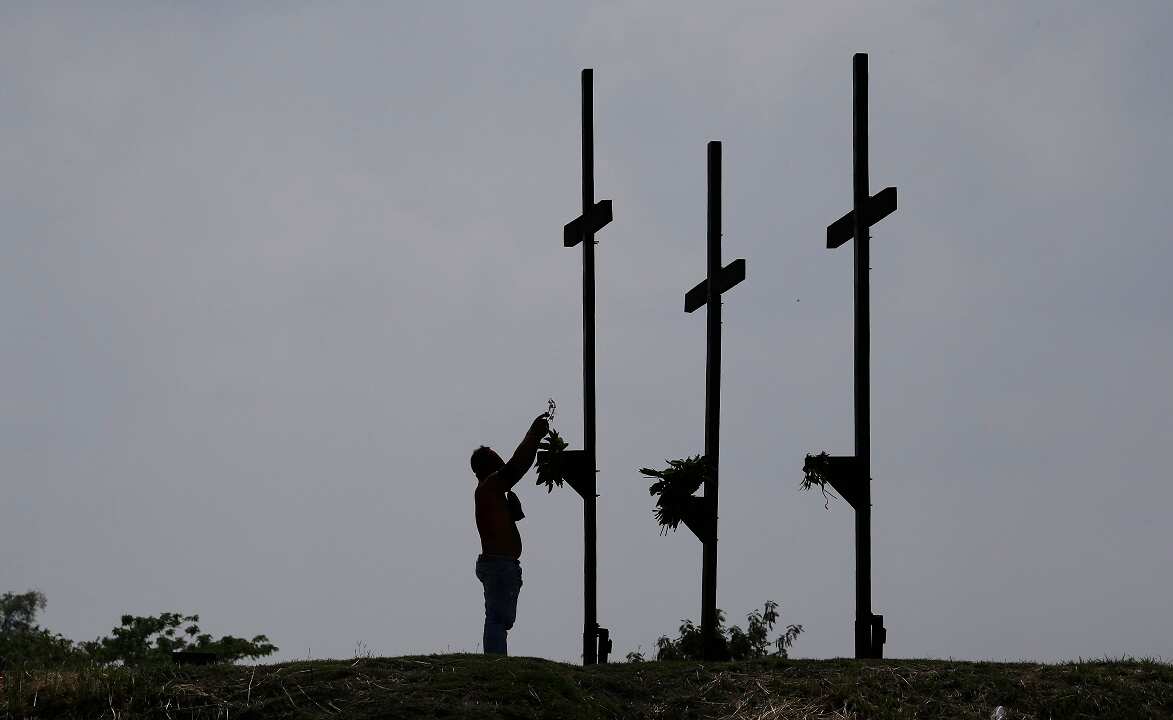 A Filipino penitent places his crown of thorns during Good Friday rituals to atone for sins.