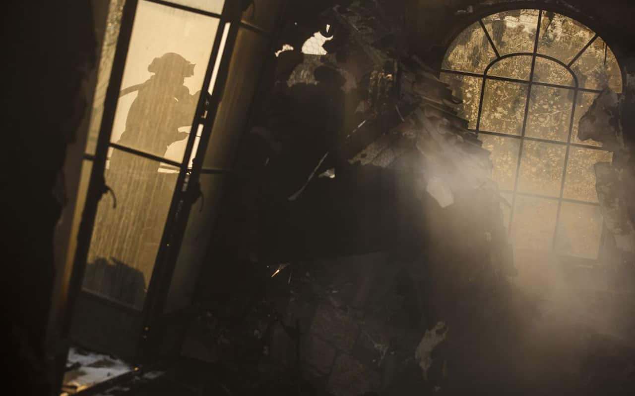 Humboldt County fire crews hose down residual heat inside a home that was destroyed by the Thomas Fire on December 17, 2017