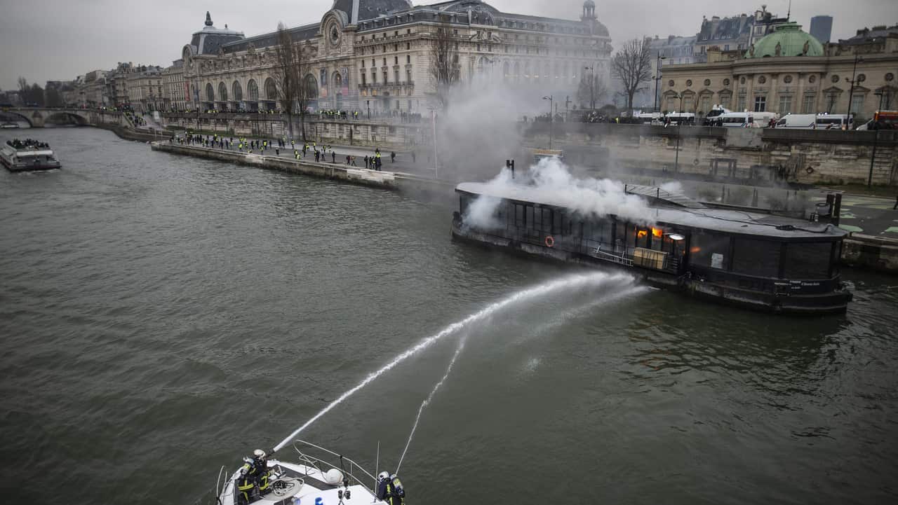 A burning boat moored next to Orsay Museum is seen during a demonstration by the "yellow vests" movement in Paris, France.