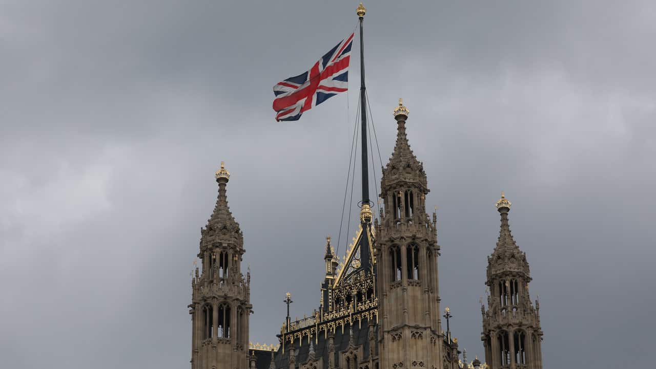 The Union flag flying above the Palace of Westminster, London..