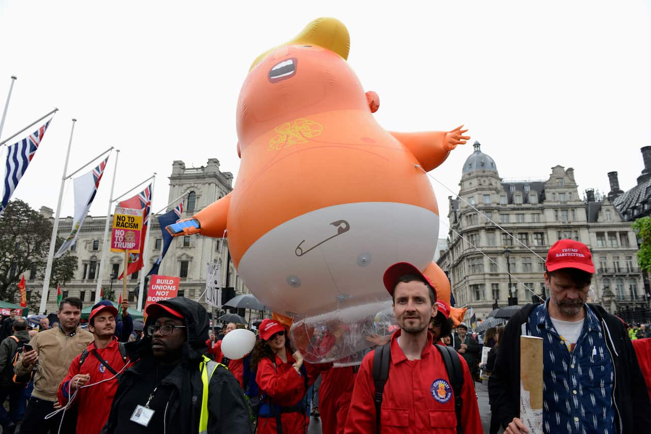 Anti-Trump protesters fly a Trump baby blimp over Parliament Square as part of the protests across London.