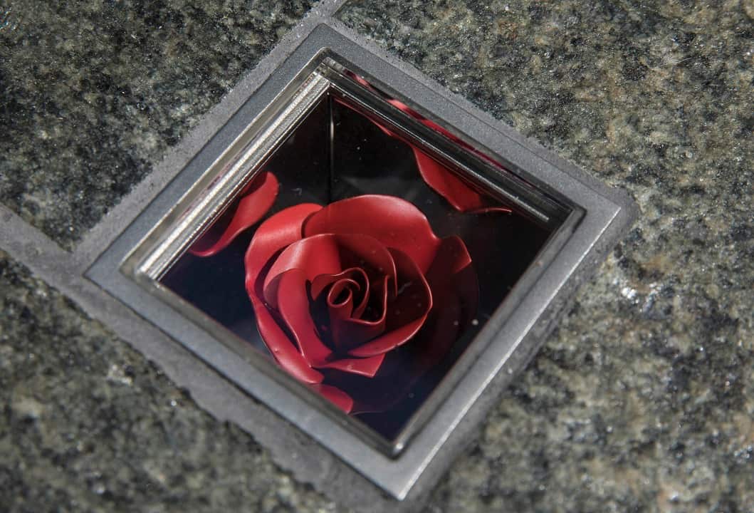The permanent memorial to the Sydney siege victims comprises of 210 individual boxes with flowers embedded in the granite pavement.