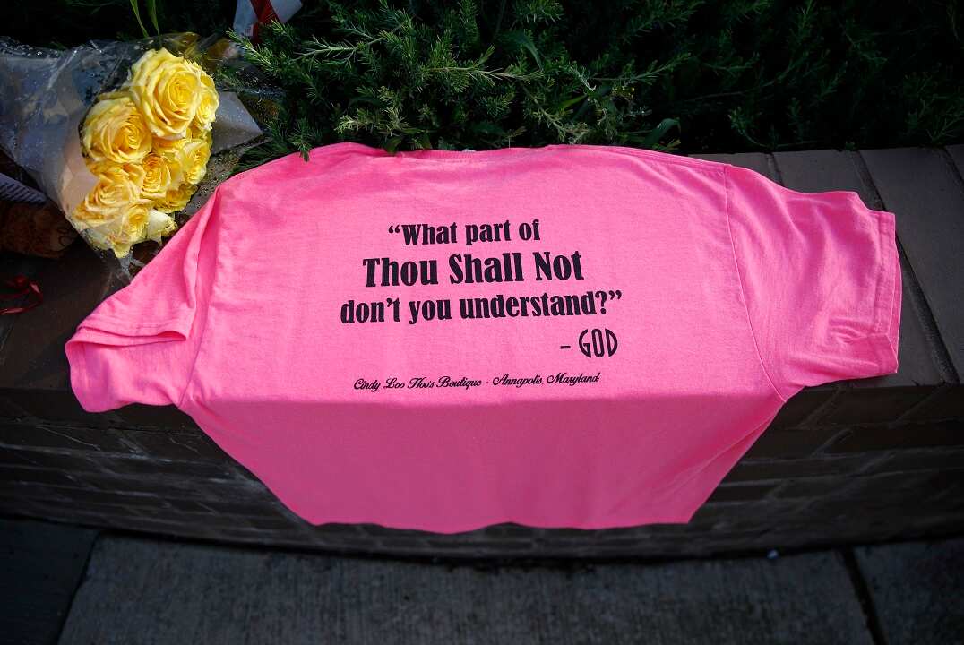 A shirt and flowers at the scene of a shooting at The Capital Gazette newspaper office.