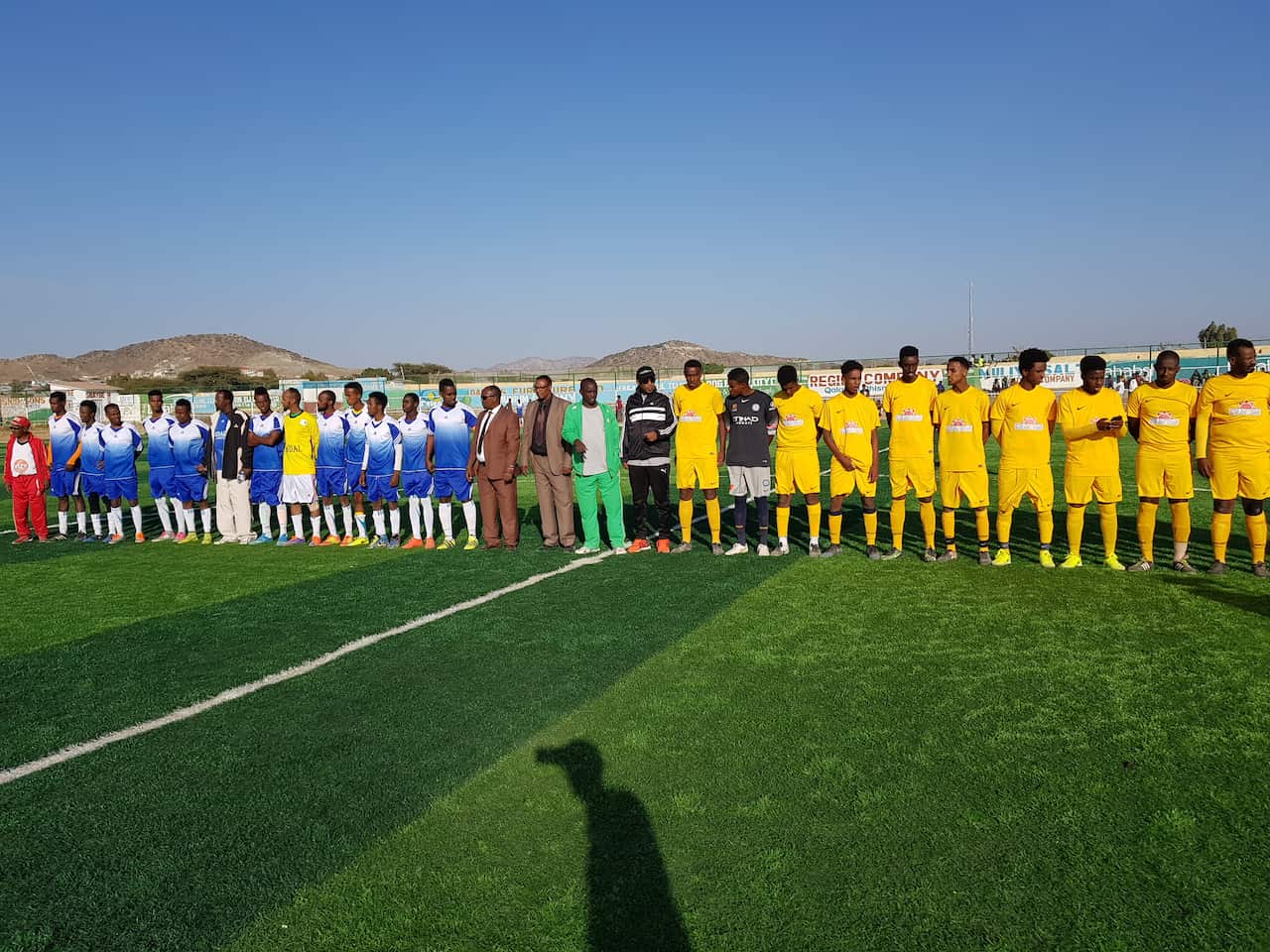 The teams line up. 