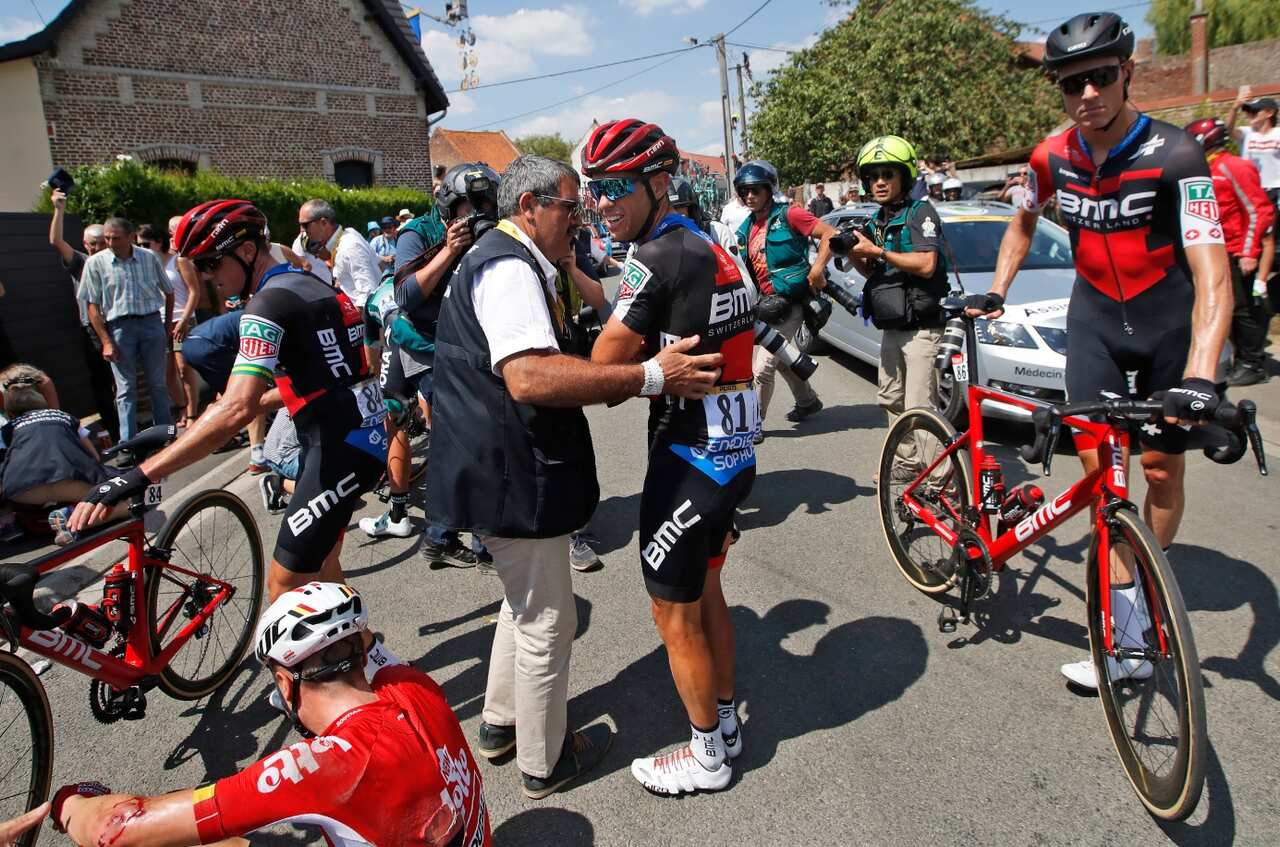 Australia's Richie Porte, center, receives medical attention after crashing during the ninth stage of the Tour de France 