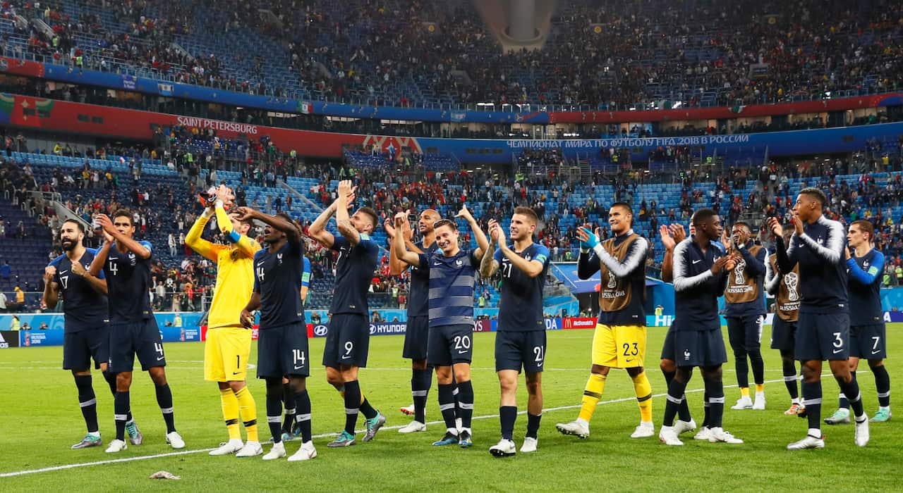 Players of France celebrate with fans after the FIFA World Cup 2018 semi final soccer match between France and Belgium