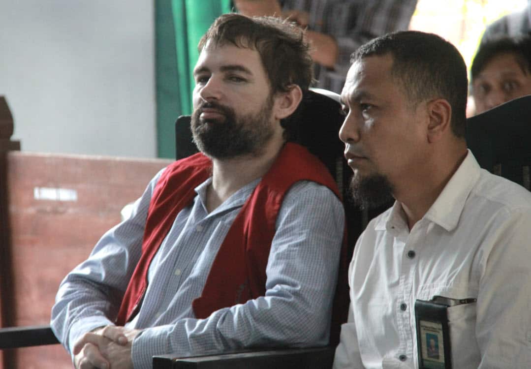 French national Felix Dorfin, left, is accompanied by an interpreter during his sentencing hearing at a district court in Mataram, Lombok Island, Indonesia, Monday, May 20, 2019 (AAP)