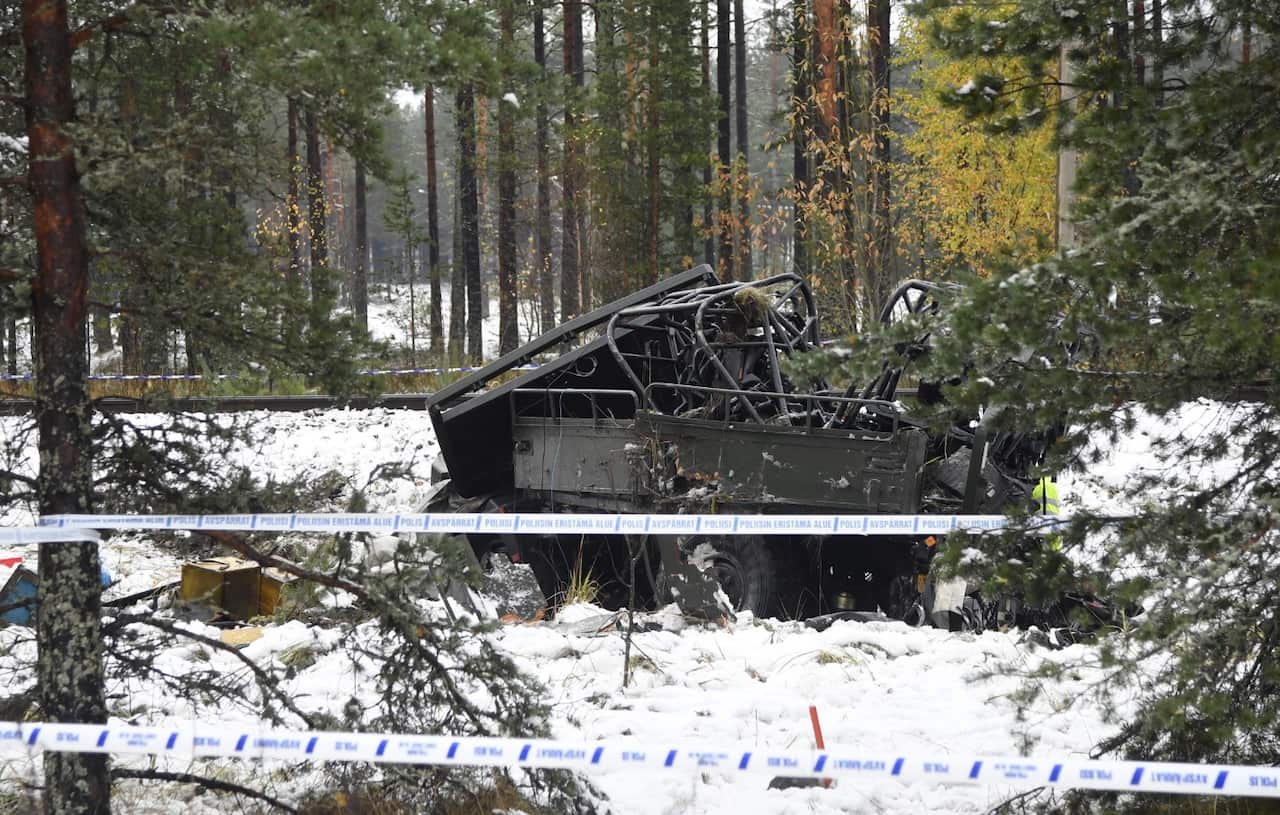 The wreckage of a military truck lays by the side of the railway tracks after several people were killed in a crash with a train in southern Finland (AAP)