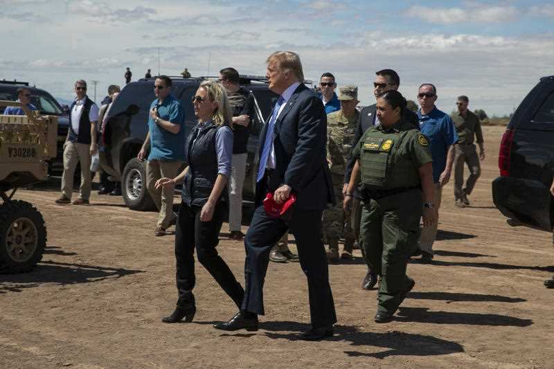 The president and Homeland Security Secretary Kirstjen Nielsen as they visit a newly constructed section of border wall.