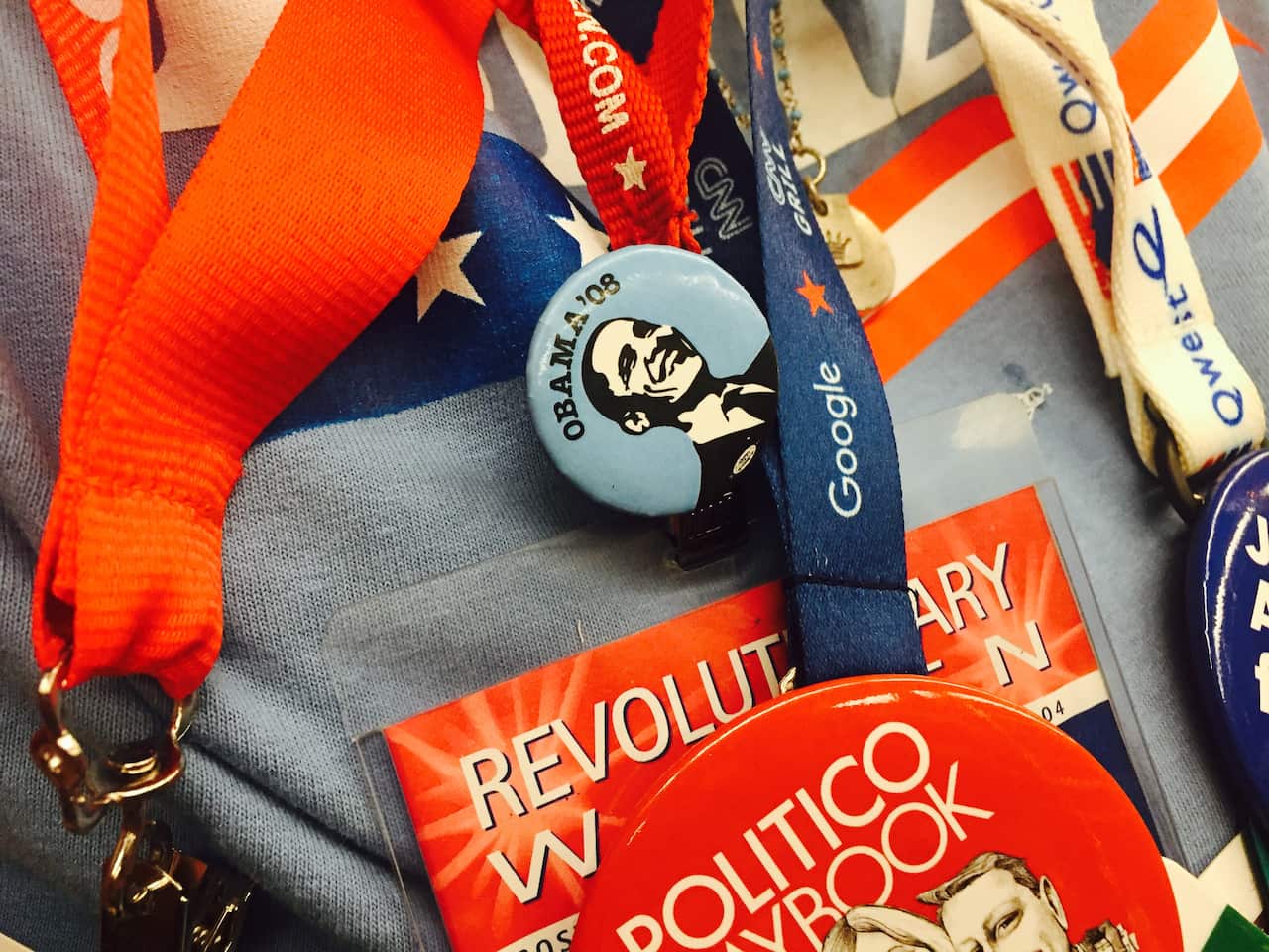 An Obama 08 pin sourrounded by lanyards.