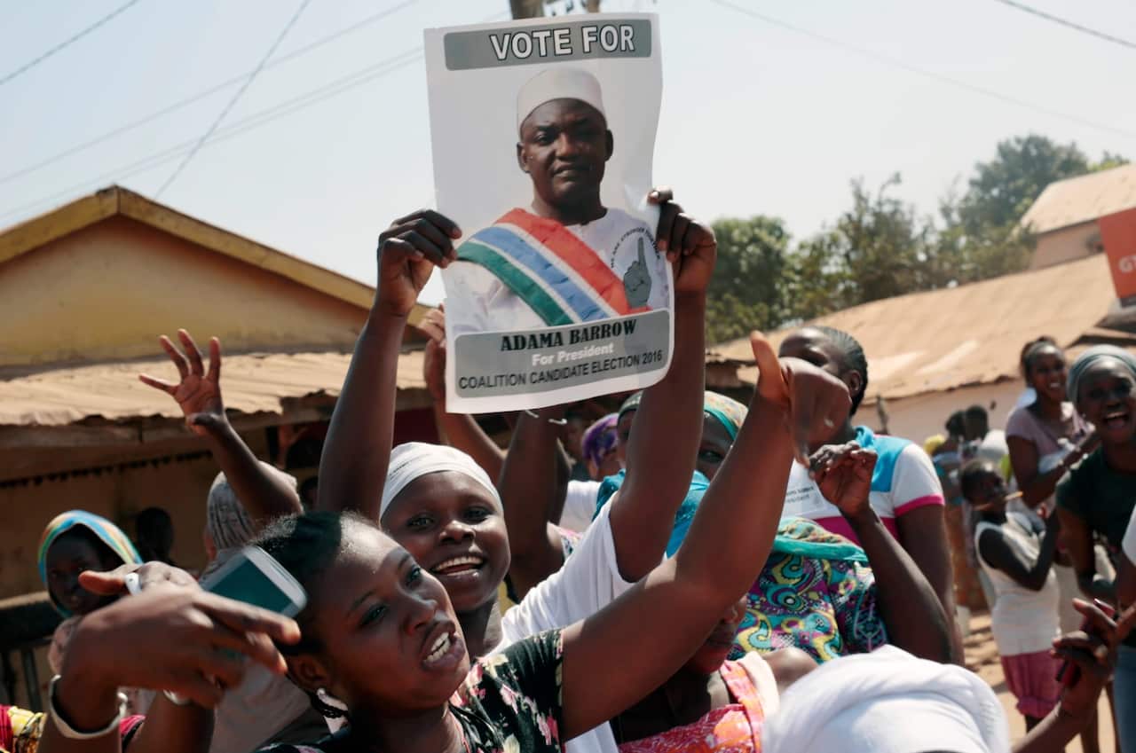 Gambians celebrate the victory of opposition coalition candidate Adama Barrow (AAP)
