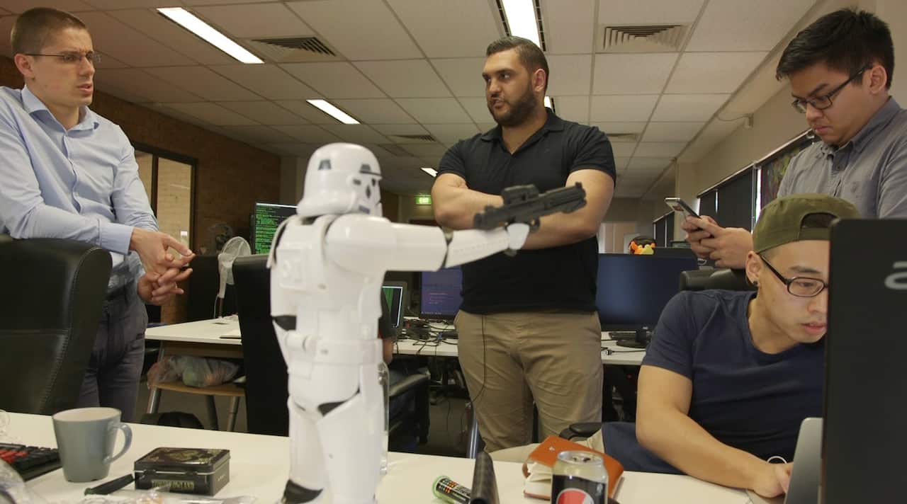 Riad chats with colleagues under the watchful eye of a Stormtrooper.