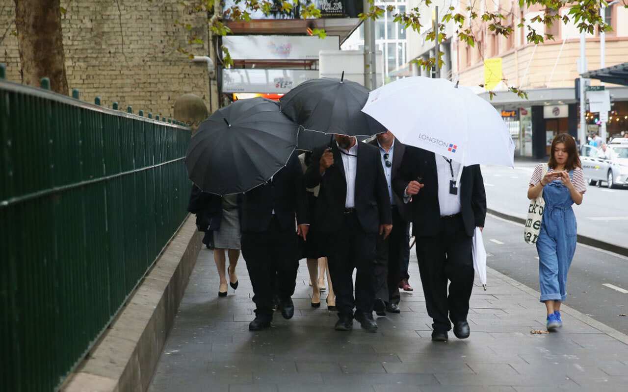 Bodyguards surround Yunxiang Gao as he arrives at court on April 10, 2018 in Sydney, Australia.