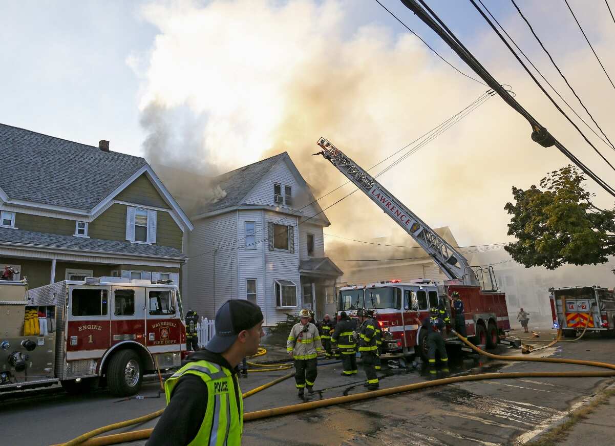 Firefighters battle a fire in a house in Lawrence, Massachusetts, USA, 13 September 2018.