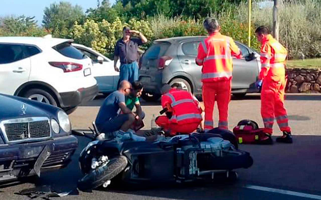 Ambulance personnel tend to actor George Clooney at the scene of a scooter accident near Olbia in Italy.