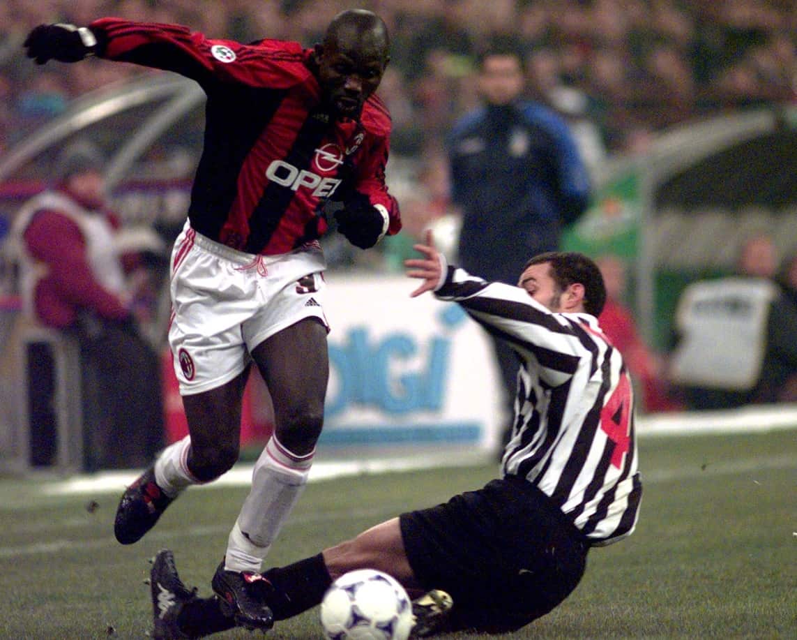 AC Milan striker George Weah, left, dribbles past Juventus Uruguayan defender Paolo Montero in 1999 (AAP)