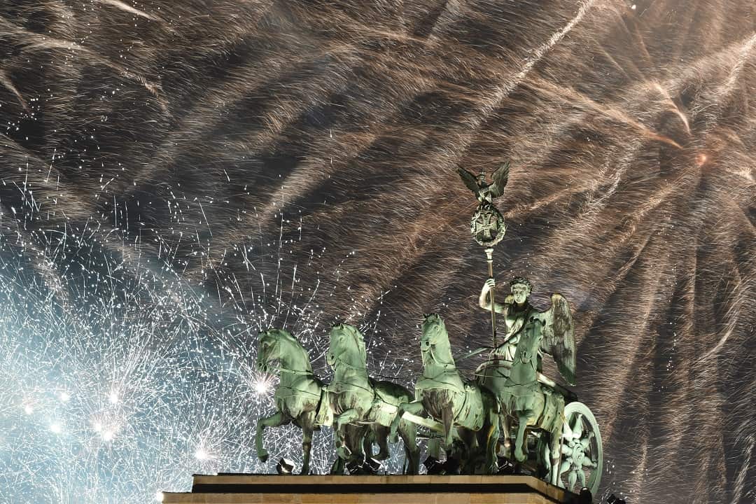 Fireworks illuminate the sky over the Quadriga statue of Germany's Brandenburg Gate.