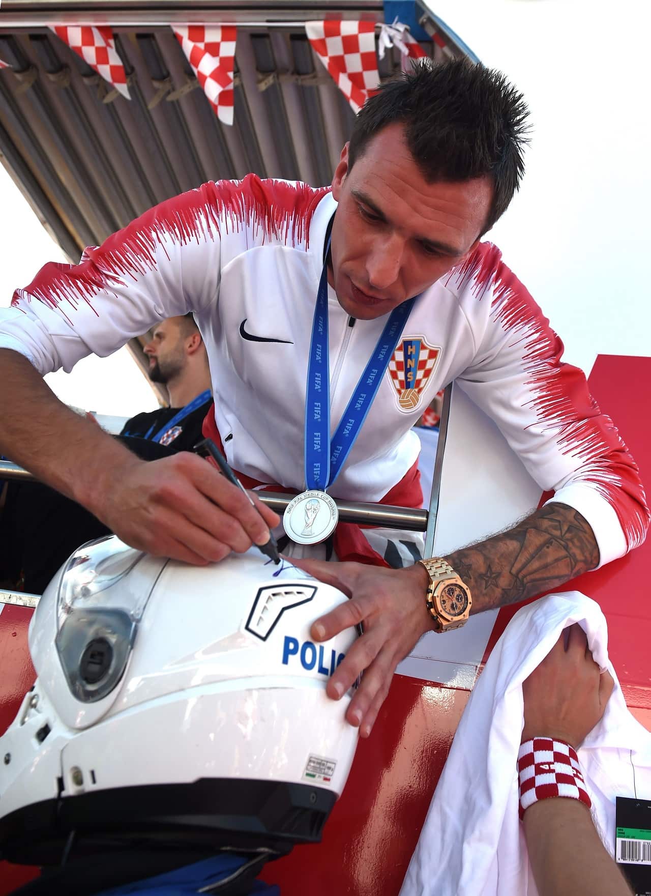 Forward Mario Mandzukic gives an autograph.