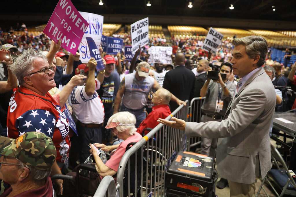CNN reporter Jim Acosta (R) speaks to people before the arrival of President Donald Trump for his Make America Great Again Rally at the Florida State Fair Grounds Expo Hall on July 31, 2018 in Tampa, Florida.
