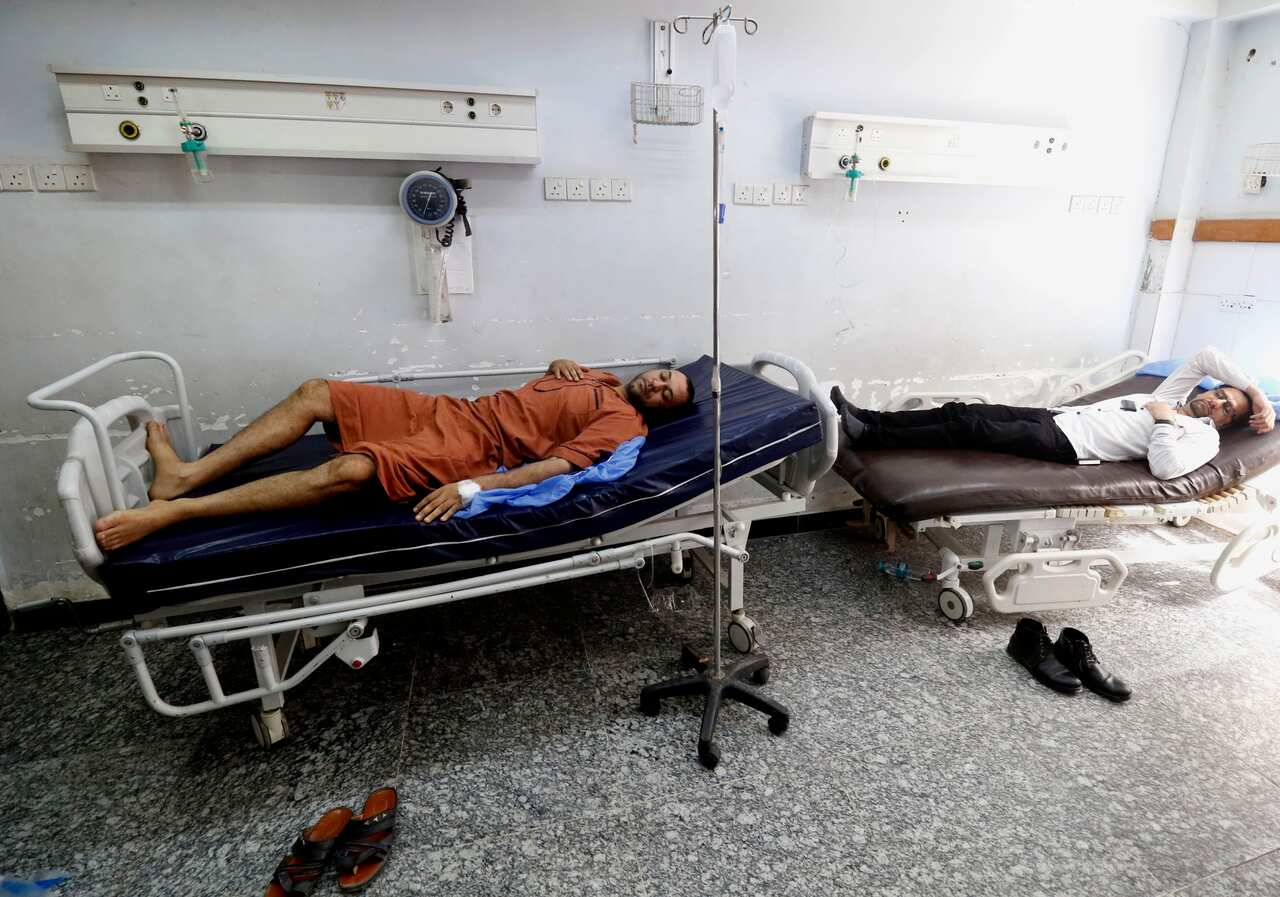 Iraqi men lie at a hospital in Basra in southern Iraq, on August 29, 2018, after falling ill from drinking polluted tap water.