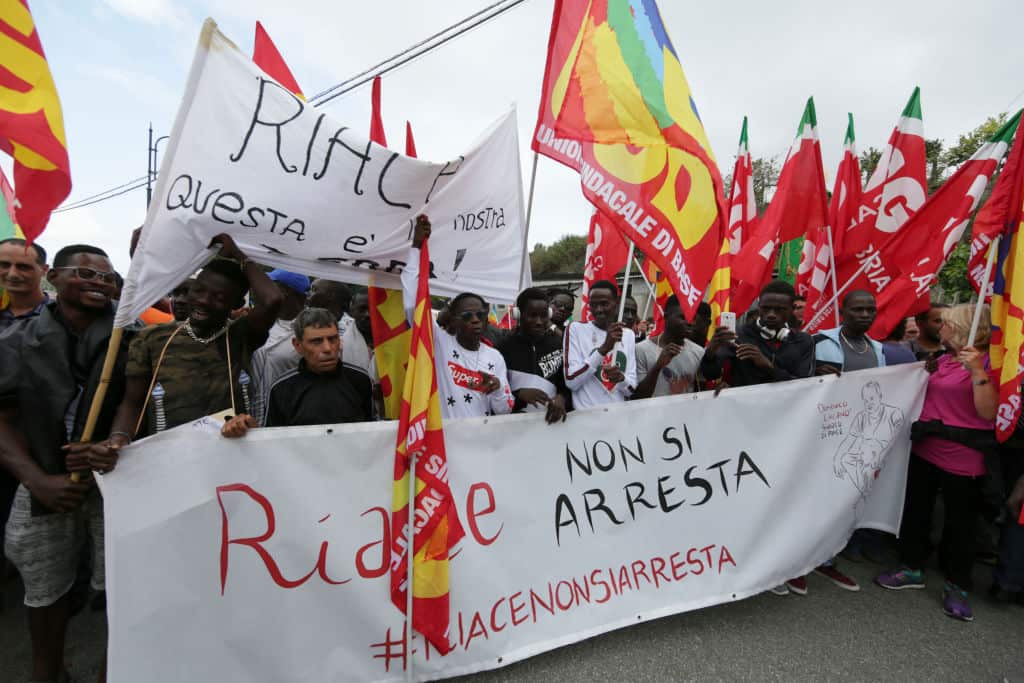 Demonstrators rally in solidarity of Domenico Lucano, mayor of Riace, who was arrested for helping illegal immigrants in his village.