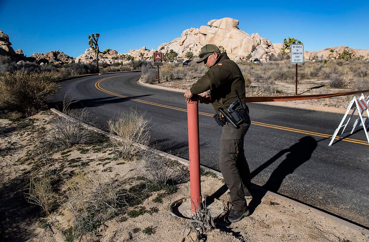 A park ranger closes off a road in Joshua Tree National Park.