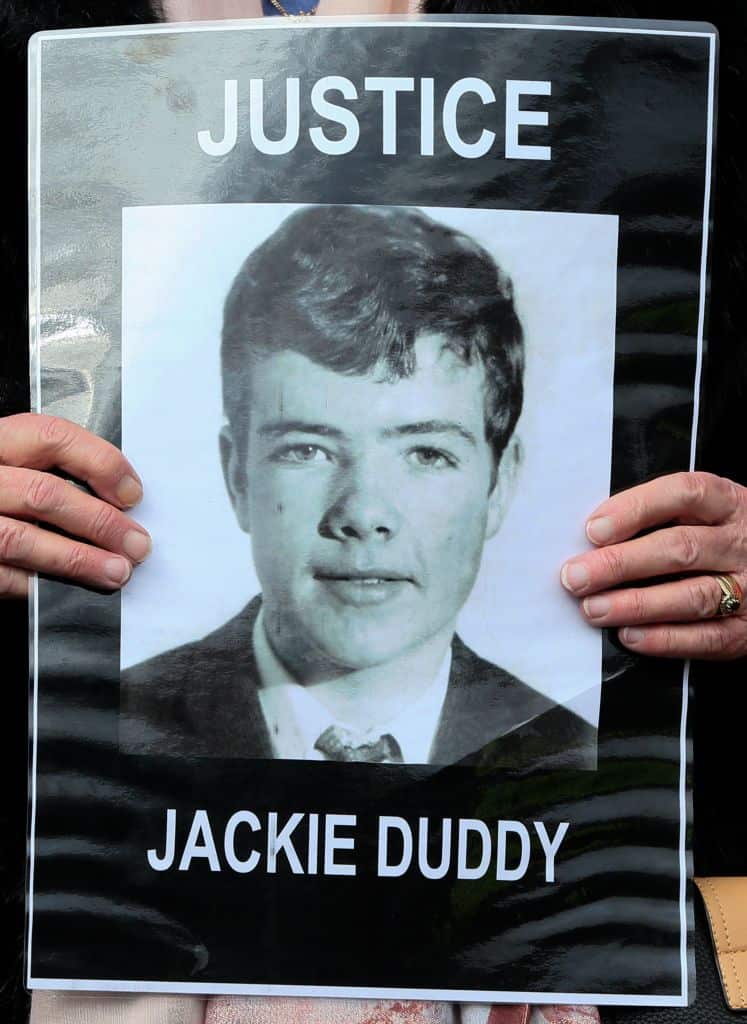 A relative holds a portrait of Jackie Duddy, one of the 14 victims of the 'Bloody Sunday' killings in Derry.