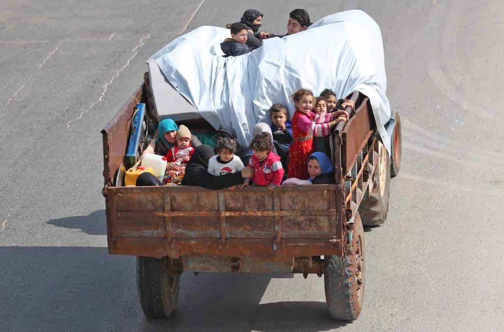 A Syrian family, riding on the back of a truck, flee from reported regime shelling on the southern countryside of the rebel-held Idlib province this week. 