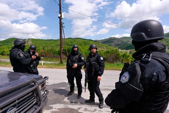 Members of Kosovo Police Special Unit secure the area near the village of Cabra, near the town of Mitrovica 