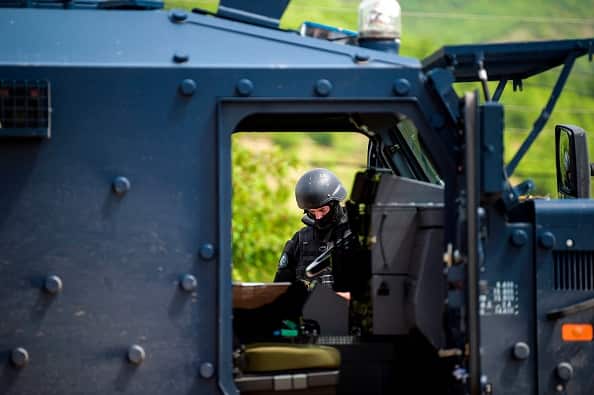 Members of Kosovo Police Special Unit secure the area near the village of Cabra, near the town of Mitrovica.