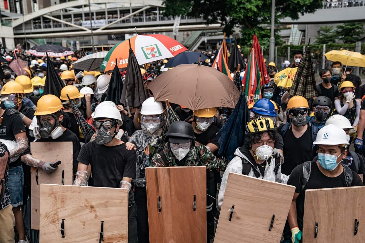 Anti-extradition protesters use makeshift shields to defend themselves.