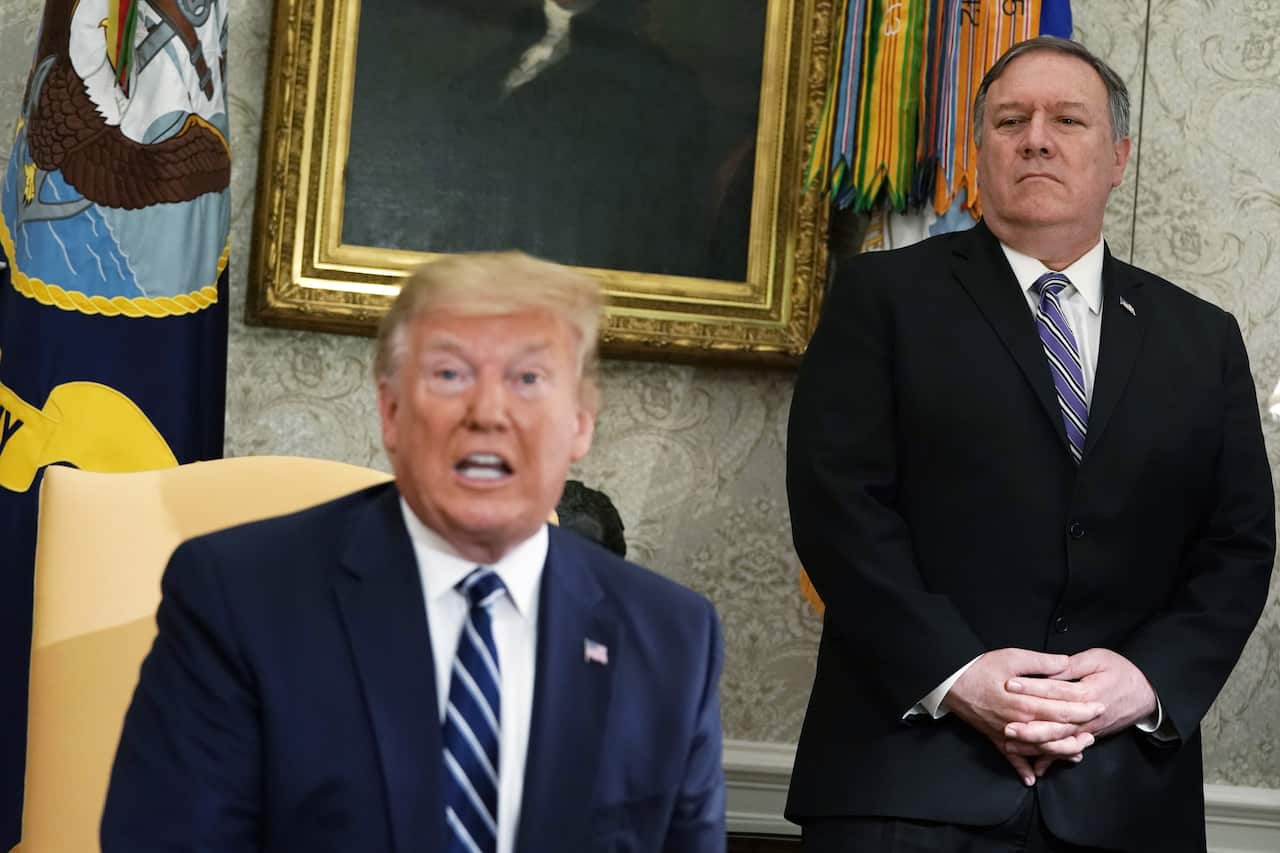 Secretary of State Mike Pompeo looks on as President Donald Trump speaks in the Oval Office of the White House.