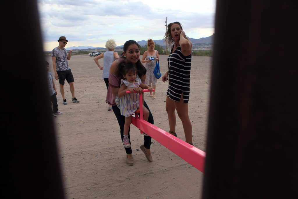 American and Mexican families play with a toy called "up and down" (Seesaw swing) over the Mexican border with US at the Anapra zone in Ciudad Juarez, Chihuahua State, Mexico on July 28, 2019. (Photo by LUIS TORRES / AFP)        (Photo credit should read 