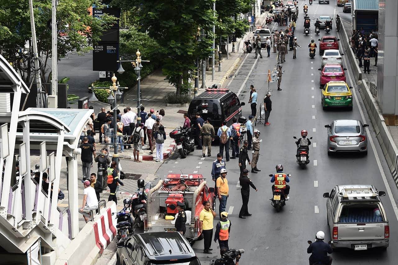 Onlookers and the police gather at the scene of an explosion.