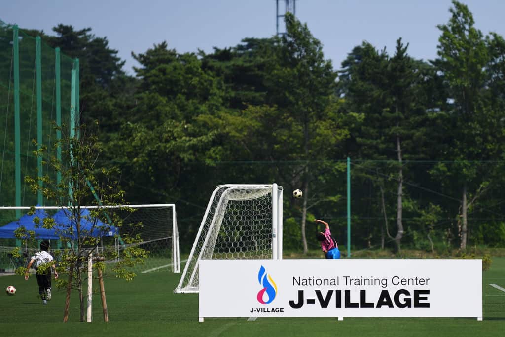 Children play football at the J-Village during a media tour in Naraha, Fukushima prefecture on August 2, 2019.