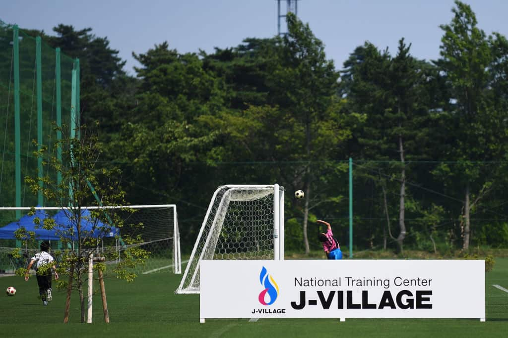 Children play football at the J-Village during a media tour in Naraha, Fukushima prefecture on August 2, 2019. 