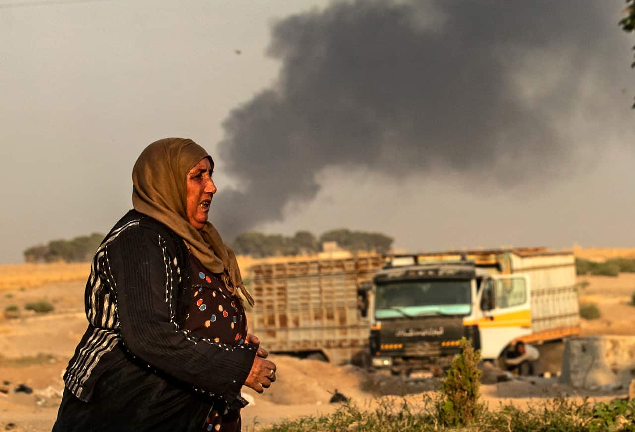 Smoke billows after Turkish bombardment in Syria's northeastern town of Ras al-Ain.