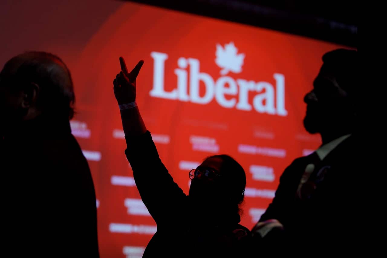 Liberal supporters react as they watch results roll in.
