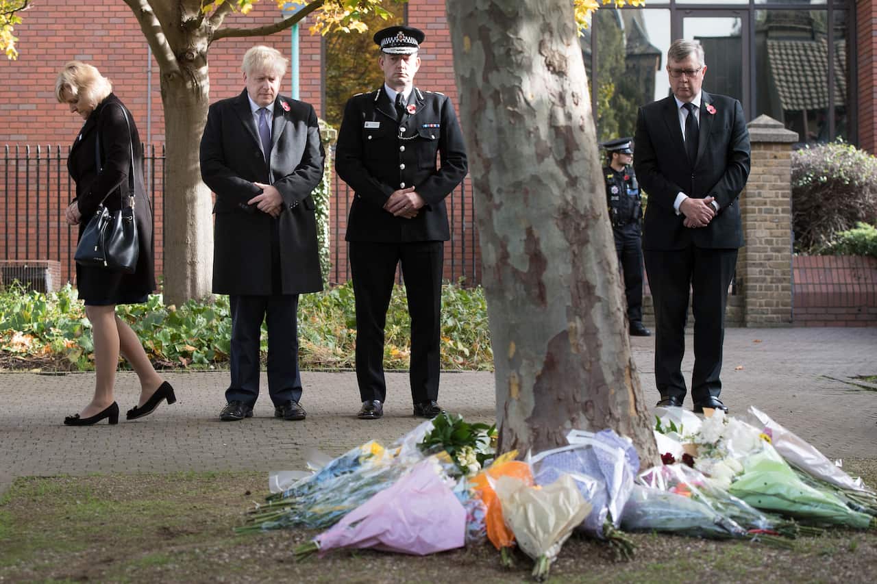 UK Prime Minister Boris Johnson (2L) stands with with Chief Constable Ben-Julian Harrington (C) following the discovery of 39 bodies concealed in a lorry.