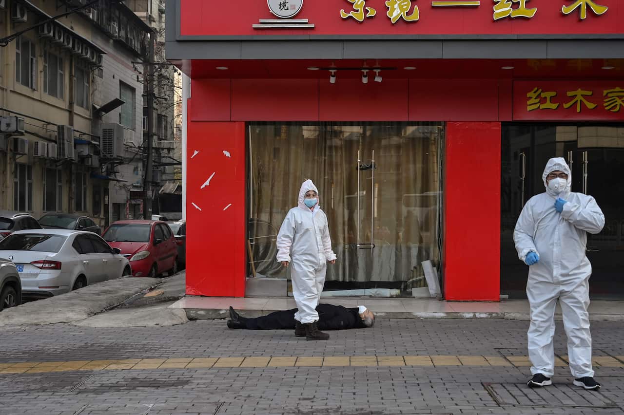 Health officials in protective suits arrive to check on the man. 