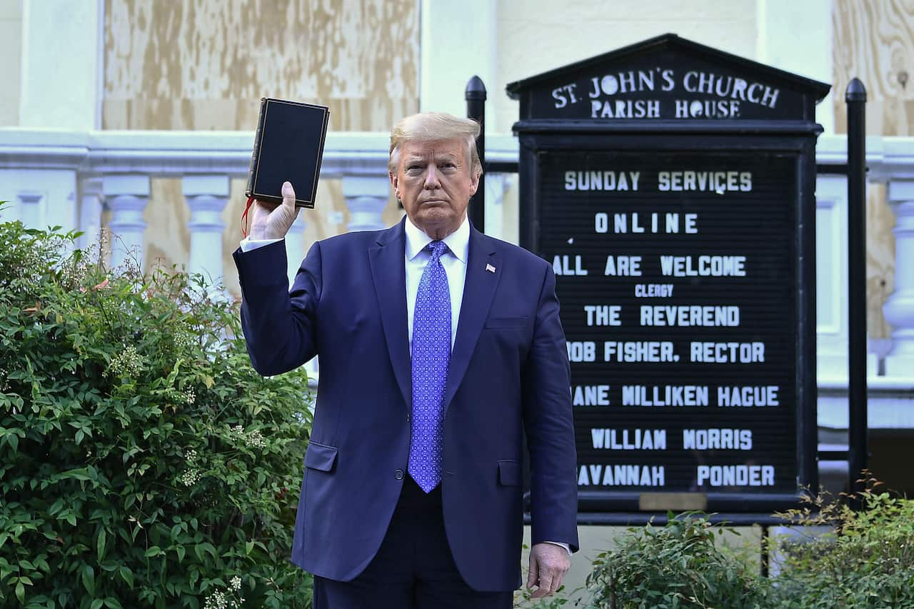 US President Donald Trump holds up a Bible outside of St John's Episcopal Church.