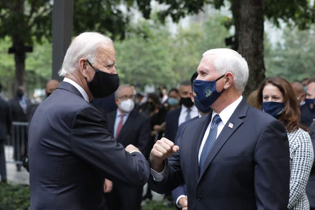 Democratic presidential nominee Joe Biden (L) and US Vice President Mike Pence (R) greet each other during a 9/11 memorial service. 