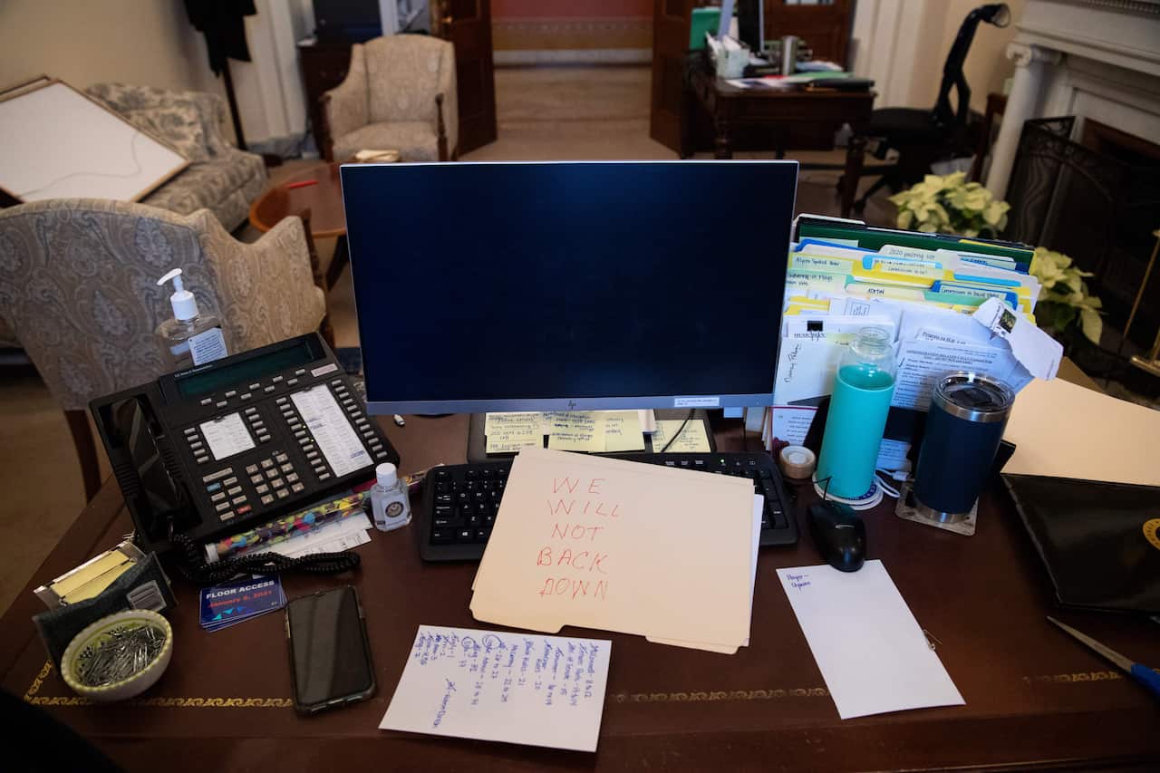 A note left by a protester in Nancy Pelosi's office: "We will never back down". 