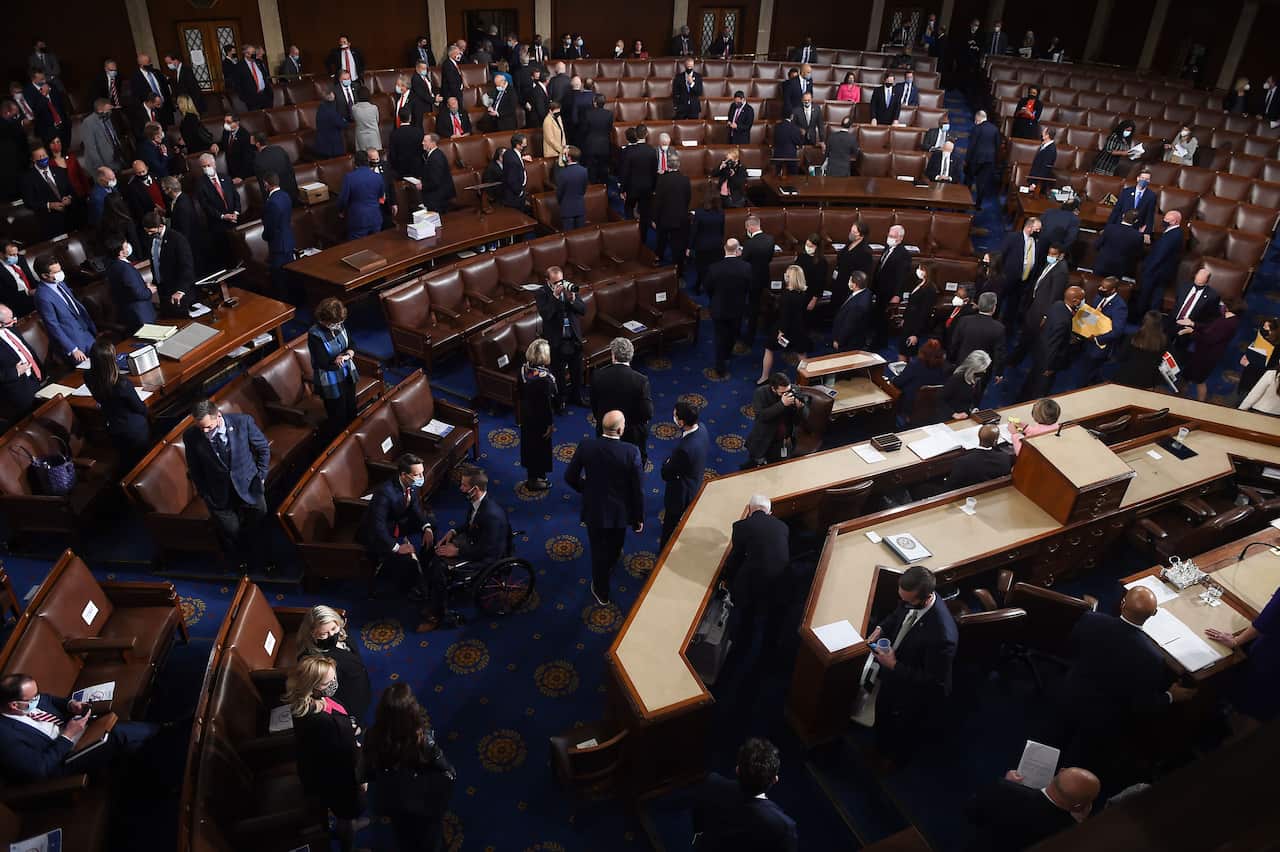 Members of the Congress prepare to evacuate as the joint session is interrupted by violent protesters.