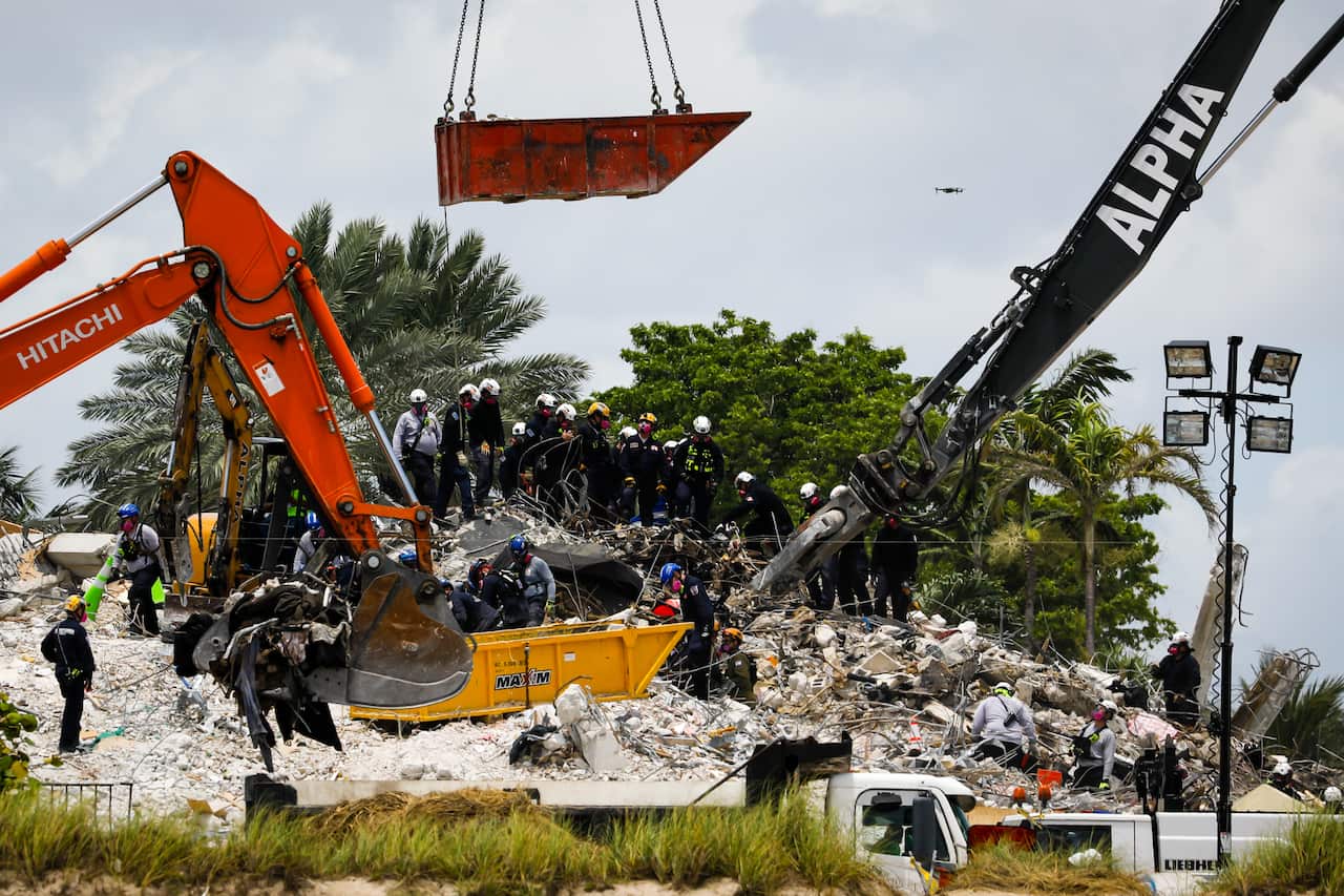 Rescue workers are seen at the Champlain Towers site in Surfside, Florida, on 5 July, 2021.